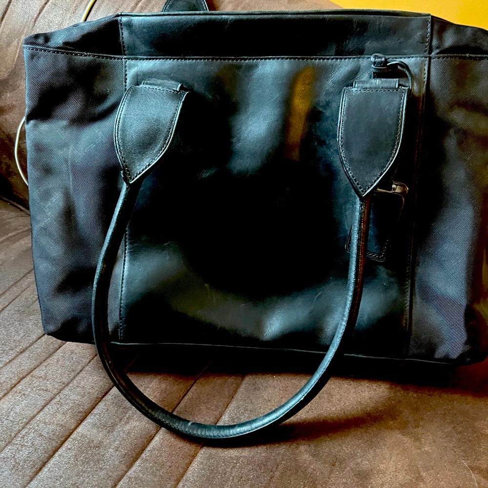 Tumi shoulder bag. Black. Practically new. Good for work, as a purse.